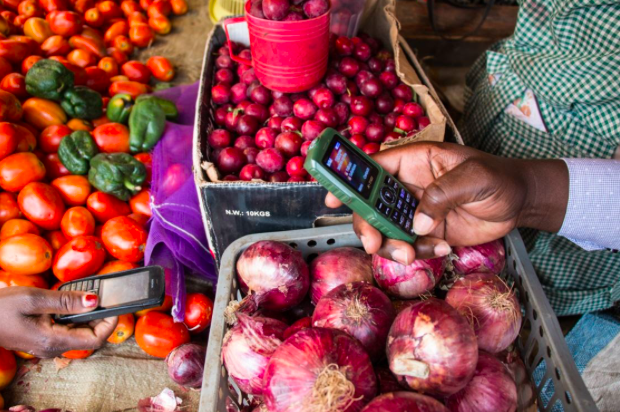 Traders using cellphones to critical tools; Picture courtesy of SautiAfrica Traders using cellphones to critical tools